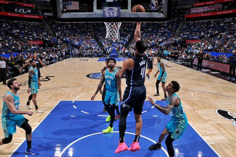 ORLANDO, FL - MARCH 19: Jalen Suggs #4 of the Orlando Magic drives to the basket during the game against the Charlotte Hornets on March 19, 2024 at the Kia Center in Orlando, Florida. NOTE TO USER: User expressly acknowledges and agrees that, by downloading and or using this photograph, User is consenting to the terms and conditions of the Getty Images License Agreement. Mandatory Copyright Notice: Copyright 2024 NBAE (Photo by Fernando Medina/NBAE via Getty Images)