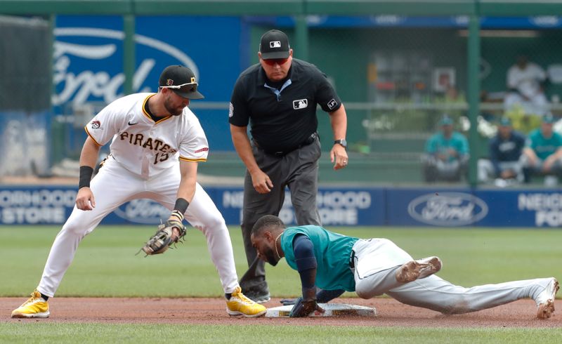Aug 17, 2024; Pittsburgh, Pennsylvania, USA;  Seattle Mariners second baseman Jorge Polanco (7) steals second base as Pittsburgh Pirates second baseman Jared Triolo (19) looks to place a tag during the first inning at PNC Park. Mandatory Credit: Charles LeClaire-USA TODAY Sports