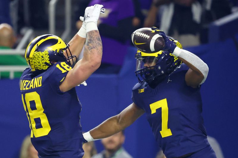 Jan 8, 2024; Houston, TX, USA; Michigan Wolverines running back Donovan Edwards (7) celebrates with tight end Colston Loveland (18) after scoring a touchdown against the Washington Huskies during the first quarter in the 2024 College Football Playoff national championship game at NRG Stadium. Mandatory Credit: Mark J. Rebilas-USA TODAY Sports