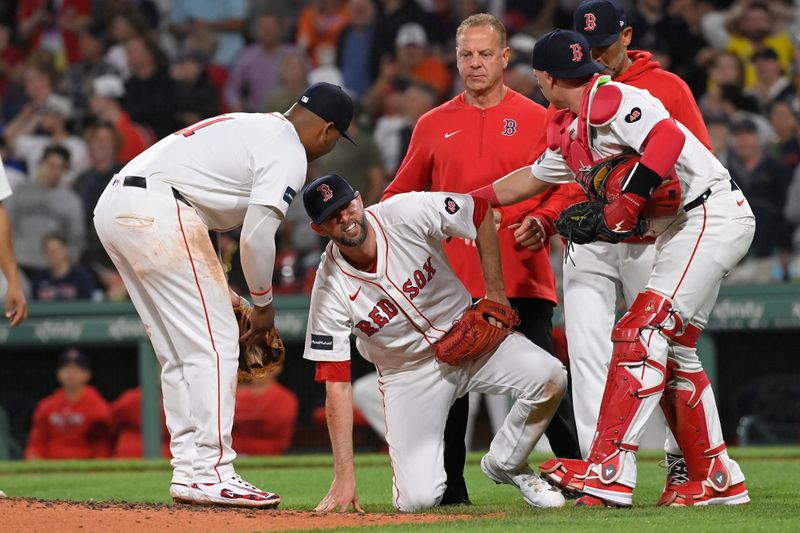 May 14, 2024; Boston, Massachusetts, USA; Boston Red Sox pitcher Chris Martin (55) reacts in pain after making a catch against the Tampa Bay Rays during the eighth inning at Fenway Park. Mandatory Credit: Eric Canha-USA TODAY Sports