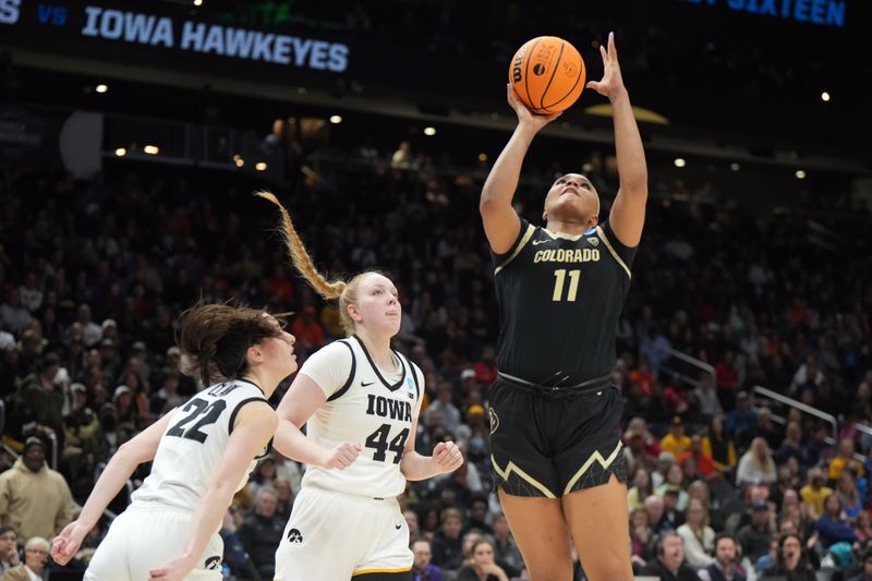 Mar 24, 2023; Seattle, WA, USA; Colorado Buffaloes center Quay Miller (11) shoots the ball against Iowa Hawkeyes guard Caitlin Clark (22) and forward Addison O'Grady (44) in the second half at Climate Pledge Arena. Mandatory Credit: Kirby Lee-USA TODAY Sports