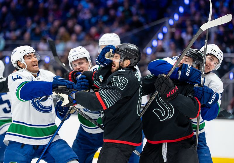 Dec 29, 2025; Seattle, Washington, USA; Vancouver Canucks forward Kiefer Sherwood (44), left, and forward Drew O'Connor (18), right, scuffle with  forward Frederick Gaudreau (89) and forward Chandler Stephenson (9) during the second period at Climate Pledge Arena. Mandatory Credit: Stephen Brashear-Imagn Images