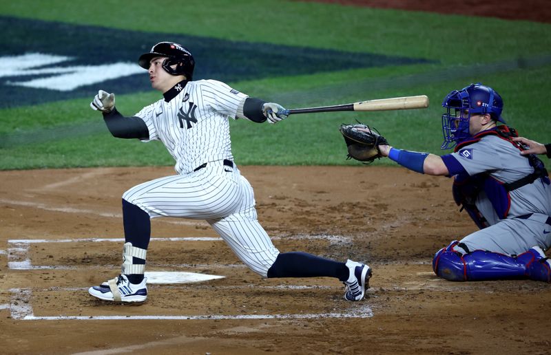 Oct 30, 2024; New York, New York, USA; New York Yankees shortstop Anthony Volpe (11) doubles during the second inning against the Los Angeles Dodgers in game five of the 2024 MLB World Series at Yankee Stadium. Mandatory Credit: Wendell Cruz-Imagn Images