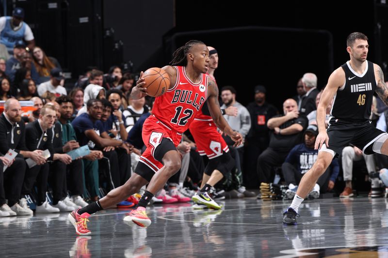 MEMPHIS, TN - FEBRUARY 8: Ayo Dosunmu #12 of the Chicago Bulls dribbles the ball during the game against the Memphis Grizzlies on February 8, 2024 at FedExForum in Memphis, Tennessee. NOTE TO USER: User expressly acknowledges and agrees that, by downloading and or using this photograph, User is consenting to the terms and conditions of the Getty Images License Agreement. Mandatory Copyright Notice: Copyright 2024 NBAE (Photo by Joe Murphy/NBAE via Getty Images)