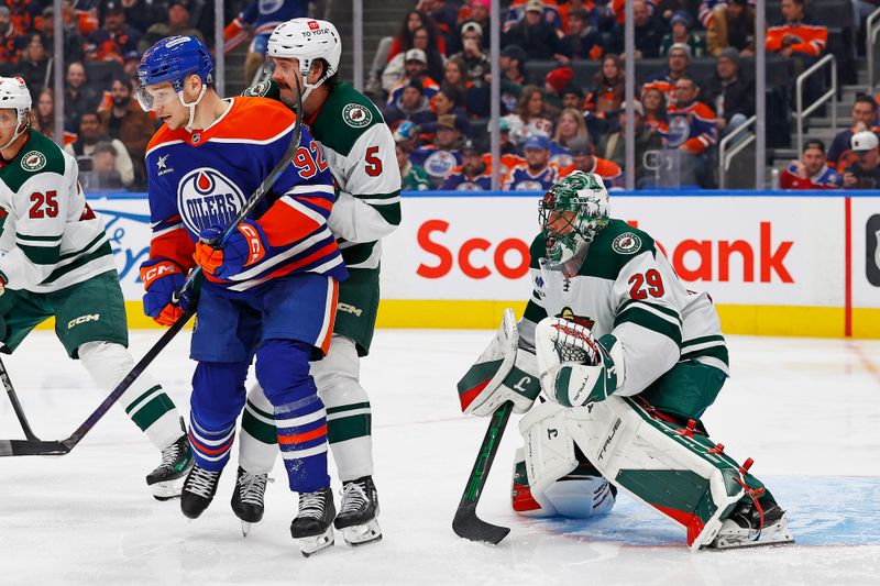 Nov 21, 2024; Edmonton, Alberta, CAN; Edmonton Oilers forward Vasily Podkolzin (92) battles with Minnesota Wild defensemen Jake Middleton (5) in front of goaltender Marc-Andre Fleury (29) during the third period at Rogers Place. Mandatory Credit: Perry Nelson-Imagn Images