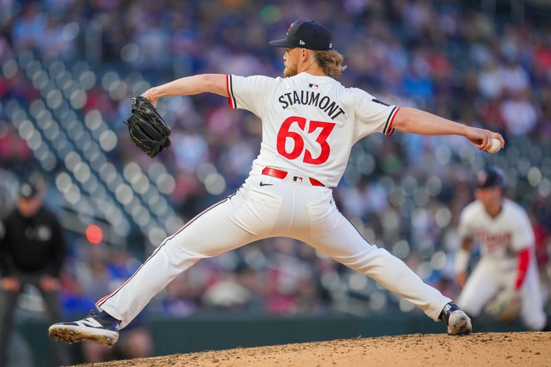 May 28, 2024; Minneapolis, Minnesota, USA; Minnesota Twins pitcher Josh Staumont (63) pitches against the Kansas City Royals in the seventh inning at Target Field. Mandatory Credit: Brad Rempel-USA TODAY Sports