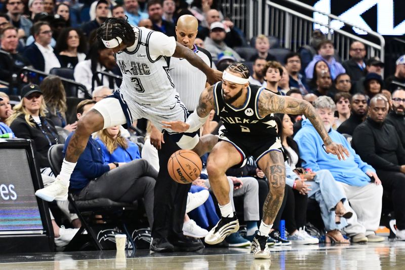 ORLANDO, FLORIDA - JANUARY 10: Gary Trent Jr. #5 of the Milwaukee Bucks and Kentavious Caldwell-Pope #3 of the Orlando Magic battle for possession in the first half of a game at Kia Center on January 10, 2025 in Orlando, Florida. NOTE TO USER: User expressly acknowledges and agrees that, by downloading and or using this photograph, User is consenting to the terms and conditions of the Getty Images License Agreement. (Photo by Julio Aguilar/Getty Images)