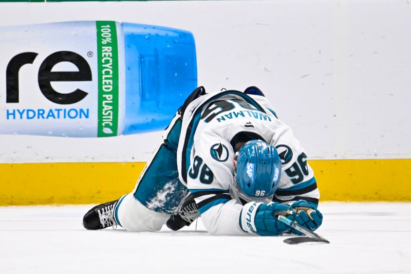 Nov 20, 2024; Dallas, Texas, USA; San Jose Sharks defenseman Jake Walman (96) lays on the ice during the third period against the Dallas Stars at the American Airlines Center. Mandatory Credit: Jerome Miron-Imagn Images