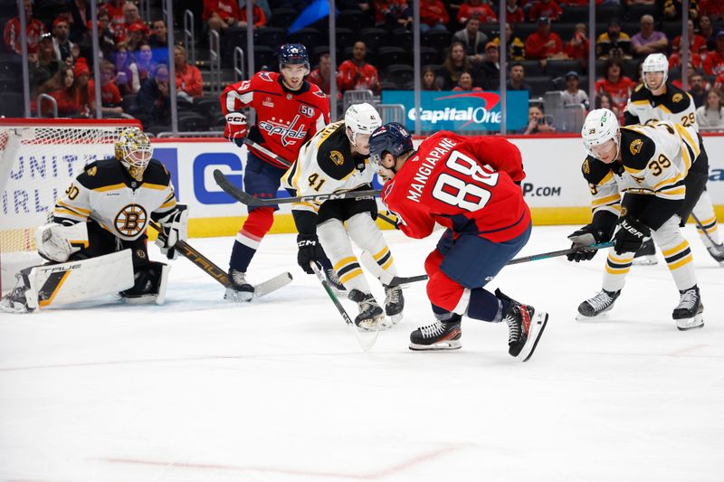 Oct 5, 2024; Washington, District of Columbia, USA; Washington Capitals left wing Andrew Mangiapane (88) shoots the puck on Boston Bruins goaltender Brandon Bussi (30) as Bruins defenseman Jackson Edward (41) defends in the first period at Capital One Arena. Mandatory Credit: Geoff Burke-Imagn Images