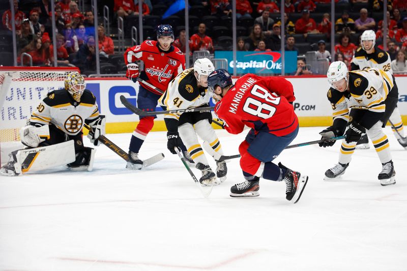 Oct 5, 2024; Washington, District of Columbia, USA; Washington Capitals left wing Andrew Mangiapane (88) shoots the puck on Boston Bruins goaltender Brandon Bussi (30) as Bruins defenseman Jackson Edward (41) defends in the first period at Capital One Arena. Mandatory Credit: Geoff Burke-Imagn Images