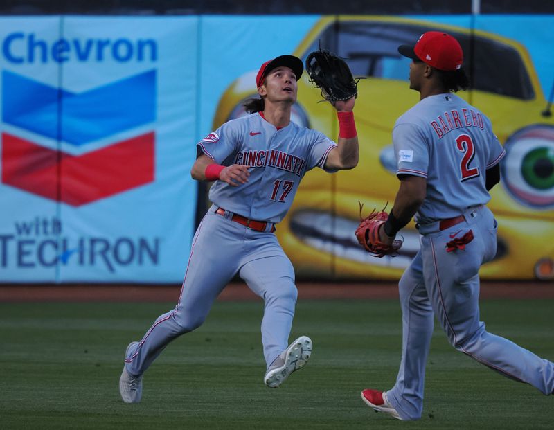 Apr 28, 2023; Oakland, California, USA; Cincinnati Reds left fielder Stuart Fairchild (17) catches the ball with shortstop Jose Barrero (2) during the first inning against the Oakland Athletics at Oakland Coliseum. Mandatory Credit: Kelley L Cox-USA TODAY Sports