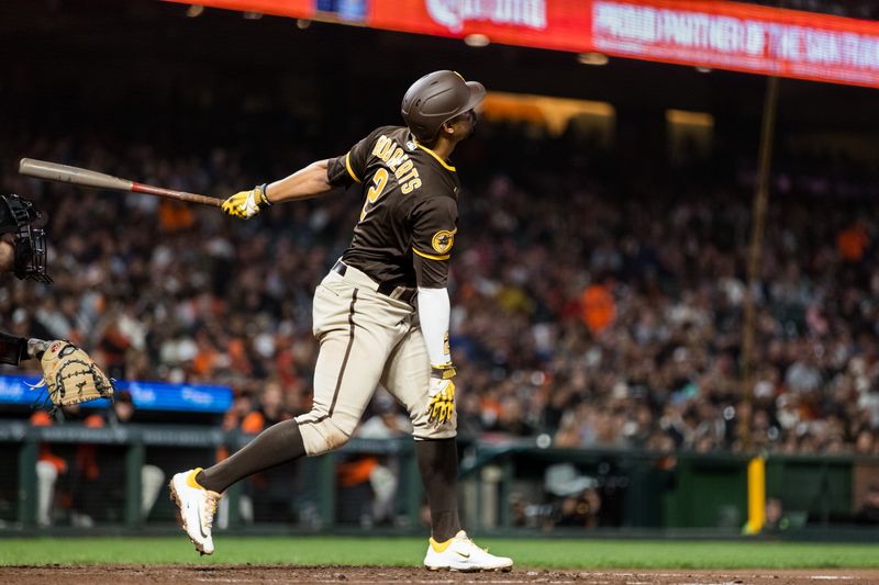 Sep 27, 2023; San Francisco, California, USA; San Diego Padres shortstop Xander Bogaerts (2) hits a sacrifice fly to drive in a run against the San Francisco Giants during the fifth inning at Oracle Park. Mandatory Credit: John Hefti-USA TODAY Sports