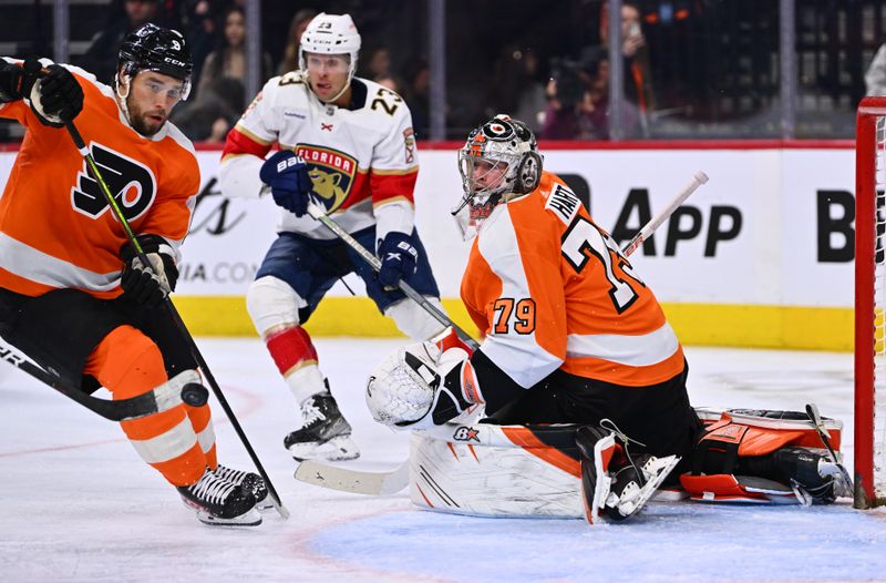 Mar 21, 2023; Philadelphia, Pennsylvania, USA; Philadelphia Flyers goalie Carter Hart (79) watches as defenseman Ivan Provorov (9), left, chases a loose puck against the Florida Panthers in the second period at Wells Fargo Center. Mandatory Credit: Kyle Ross-USA TODAY Sports