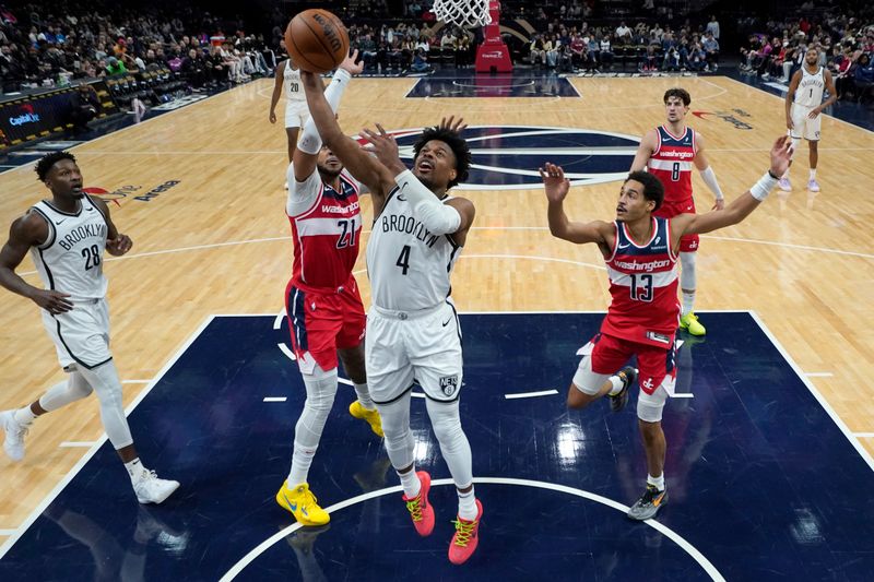 WASHINGTON, DC - DECEMBER 29: Dennis Smith Jr. #4 of the Brooklyn Nets shoots against Daniel Gafford #21 of the Washington Wizards during the first half at Capital One Arena on December 29, 2023 in Washington, DC. NOTE TO USER: User expressly acknowledges and agrees that, by downloading and or using this photograph, User is consenting to the terms and conditions of the Getty Images License Agreement. (Photo by Jess Rapfogel/Getty Images)