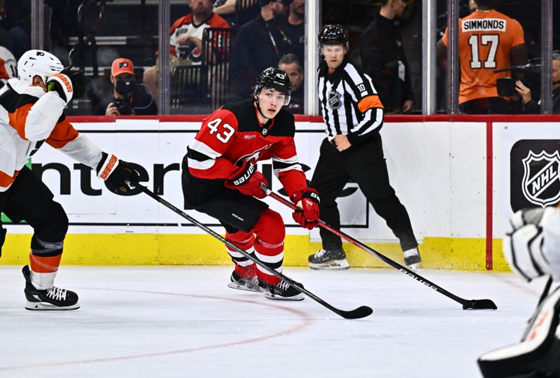 Apr 13, 2024; Philadelphia, Pennsylvania, USA; New Jersey Devils defenseman Luke Hughes (43) controls the puck against the Philadelphia Flyers in the second period at Wells Fargo Center. Mandatory Credit: Kyle Ross-USA TODAY Sports