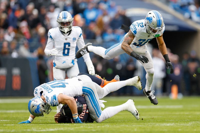 Chicago Bears quarterback Justin Fields (1) is tackled by Detroit Lions linebacker Jack Campbell (46) during the first half of an NFL football game, Sunday, Dec. 10, 2023, in Chicago. (AP Photo/Kamil Krzaczynski)