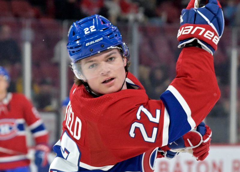 Apr 2, 2024; Montreal, Quebec, CAN; Montreal Canadiens forward Cole Caufield (22) shoots the puck during the warmup period before the game against the Florida Panthers at the Bell Centre. Mandatory Credit: Eric Bolte-USA TODAY Sports