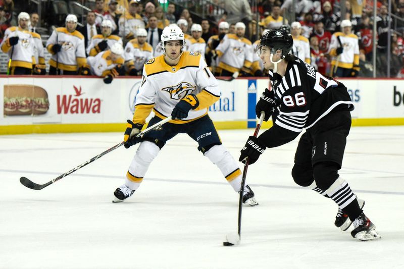 Apr 7, 2024; Newark, New Jersey, USA; New Jersey Devils center Jack Hughes (86) skates with the puck while being defended by Nashville Predators right wing Luke Evangelista (77) during overtime at Prudential Center. Mandatory Credit: John Jones-USA TODAY Sports