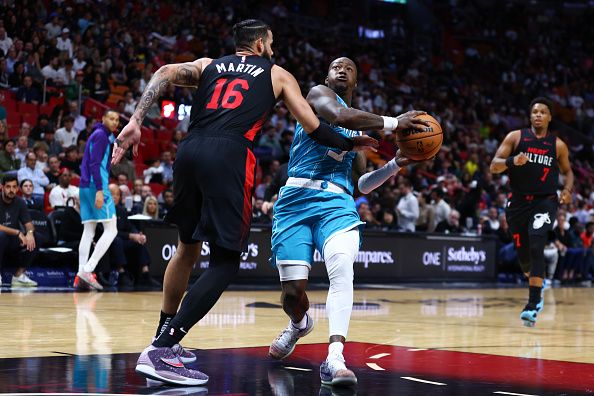 MIAMI, FLORIDA - DECEMBER 13: Terry Rozier #3 of the Charlotte Hornets drives to the basket against Caleb Martin #16 of the Miami Heat during the third quarter of the game at Kaseya Center on December 13, 2023 in Miami, Florida. NOTE TO USER: User expressly acknowledges and agrees that, by downloading and or using this photograph, User is consenting to the terms and conditions of the Getty Images License Agreement. (Photo by Megan Briggs/Getty Images)