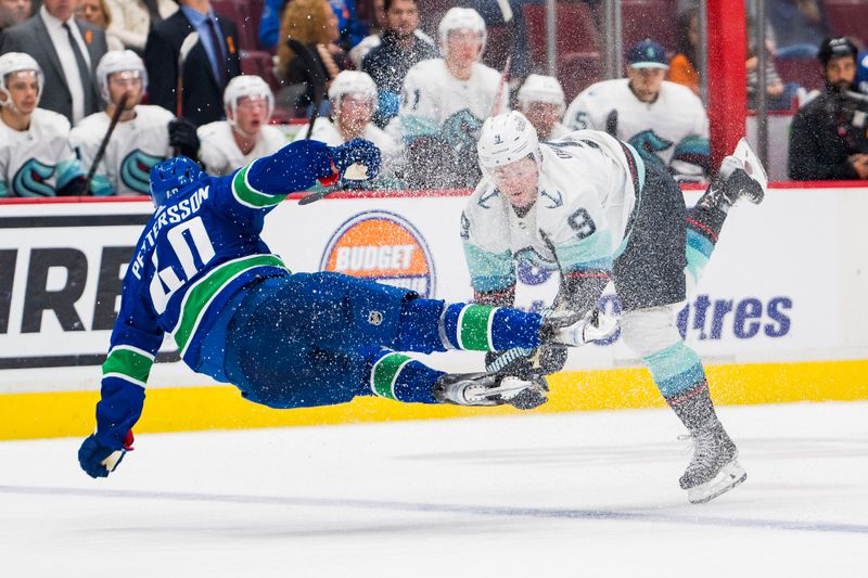 Sep 29, 2022; Vancouver, British Columbia, CAN; Vancouver Canucks forward Elias Pettersson (40) collides with Seattle Kraken forward Ryan Donato (9) in the third period at Rogers Arena. Seattle won 4-3 in overtime. Mandatory Credit: Bob Frid-USA TODAY Sports