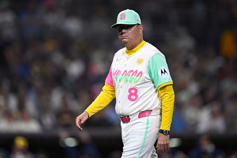 Jun 21, 2024; San Diego, California, USA; San Diego Padres manager Mike Shildt (8) walks to the dugout after a pitching change in the eighth inning against the Milwaukee Brewers at Petco Park. Mandatory Credit: Orlando Ramirez-USA TODAY Sports