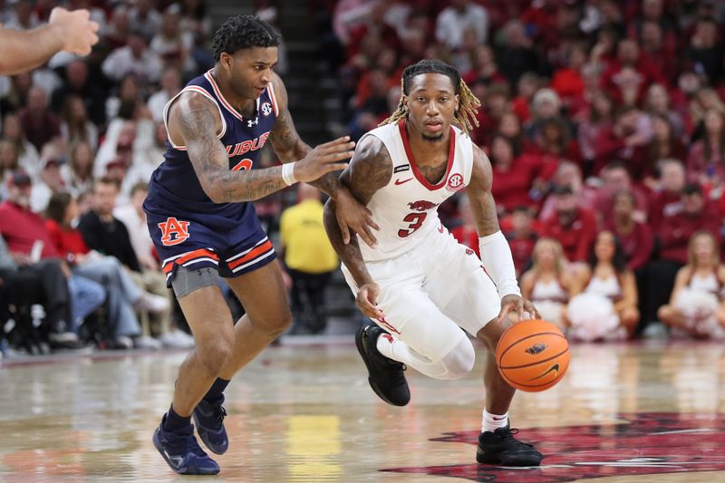 Jan 6, 2024; Fayetteville, Arkansas, USA; Arkansas Razorbacks guard El Ellis (3) drives against Auburn Tigers guard K.D. Johnson (0) during the second half at Bud Walton Arena. Auburn won 83-51. Mandatory Credit: Nelson Chenault-USA TODAY Sports