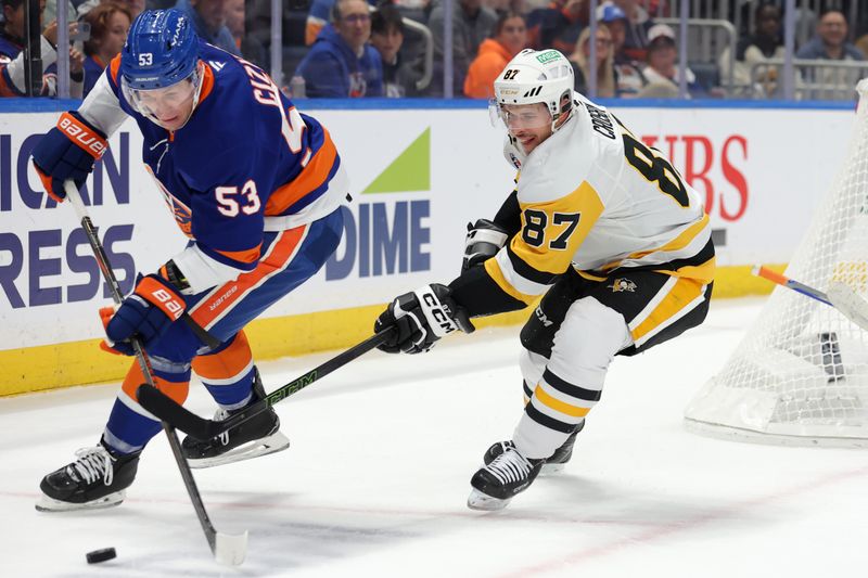 Nov 5, 2024; Elmont, New York, USA; New York Islanders center Casey Cizikas (53) and Pittsburgh Penguins center Sidney Crosby (87) fight for the puck during the first period at UBS Arena. Mandatory Credit: Brad Penner-Imagn Images