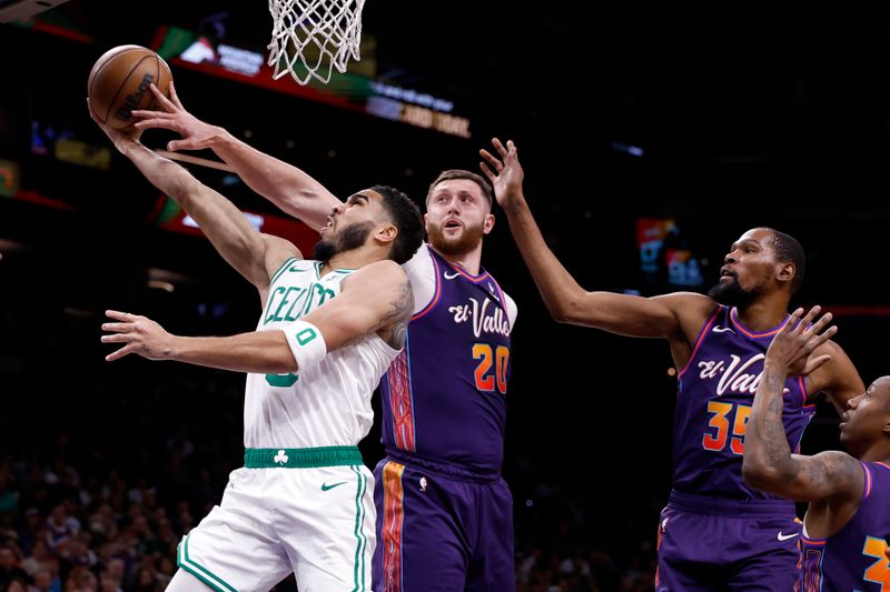 PHOENIX, ARIZONA - MARCH 09: Jusuf Nurkic #20 of the Phoenix Suns blocks a shot attempt by Jayson Tatum #0 of the Boston Celtics during the first half at Footprint Center on March 09, 2024 in Phoenix, Arizona. NOTE TO USER: User expressly acknowledges and agrees that, by downloading and or using this photograph, User is consenting to the terms and conditions of the Getty Images License Agreement.  (Photo by Chris Coduto/Getty Images)