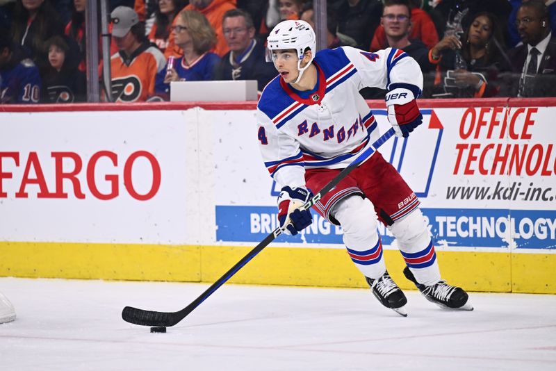 Nov 24, 2023; Philadelphia, Pennsylvania, USA; New York Rangers defenseman Braden Schneider (4) controls the puck against the Philadelphia Flyers in the second period at Wells Fargo Center. Mandatory Credit: Kyle Ross-USA TODAY Sports