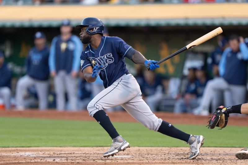 Jun 14, 2023; Oakland, California, USA;  Tampa Bay Rays left fielder Randy Arozarena (56) hits a double during the fourth inning against the Oakland Athletics at Oakland-Alameda County Coliseum. Mandatory Credit: Stan Szeto-USA TODAY Sports