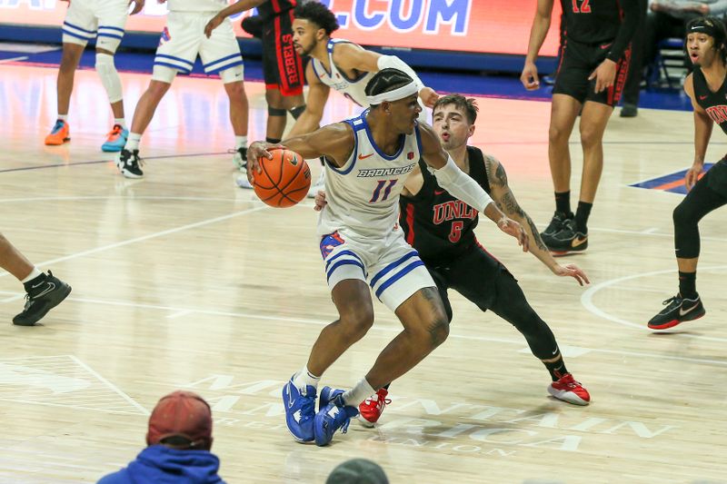 Feb 19, 2023; Boise, Idaho, USA; Boise State Broncos guard Chibuzo Agbo (11) matches up against UNLV Rebels guard Jordan McCabe (5) during the second half at ExtraMile Arena. Boise State beats UNLV 73-69. Mandatory Credit: Brian Losness-USA TODAY Sports

