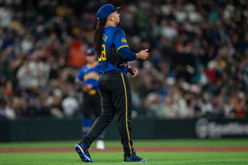 Aug 23, 2024; Seattle, Washington, USA; Starting pitcher Luis Castillo (58) reacts after giving up a home run during the sixth inning against the San Francisco Giants at T-Mobile Park. Mandatory Credit: Stephen Brashear-USA TODAY Sports