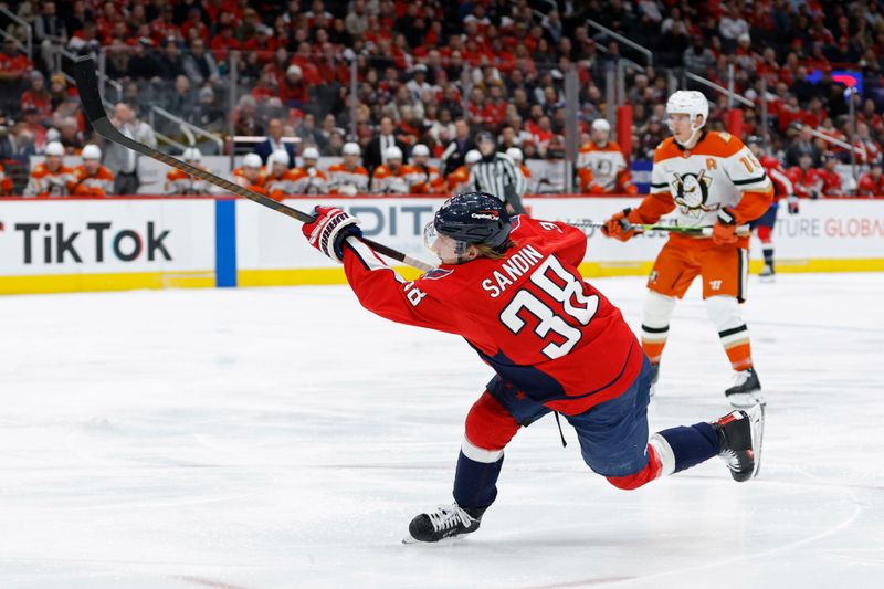 Jan 14, 2025; Washington, District of Columbia, USA; Washington Capitals defenseman Rasmus Sandin (38) shoots the puck against the Anaheim Ducks in the third period at Capital One Arena. Mandatory Credit: Geoff Burke-Imagn Images