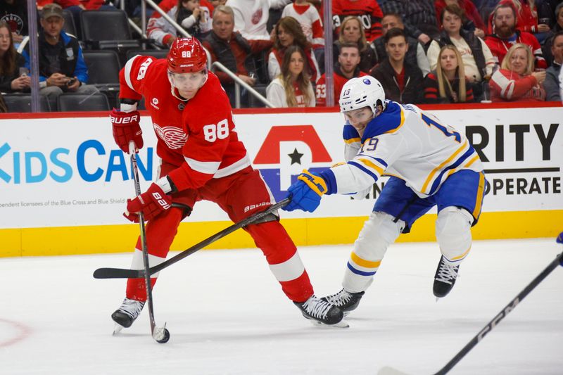 Nov 2, 2024; Detroit, Michigan, USA; Detroit Red Wings right wing Patrick Kane (88) handles the puck against Buffalo Sabres center Peyton Krebs (19) during the second period of the game at Little Caesars Arena. Mandatory Credit: Brian Bradshaw Sevald-Imagn Images