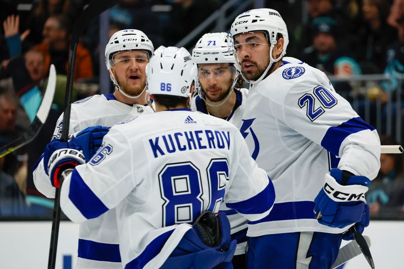 Dec 9, 2023; Seattle, Washington, USA; Tampa Bay Lightning left wing Nicholas Paul (20) celebrates with defenseman Darren Raddysh (43), right wing Nikita Kucherov (86) and center Anthony Cirelli (71) after scoring a goal against the Seattle Kraken during the third period at Climate Pledge Arena. Mandatory Credit: Joe Nicholson-USA TODAY Sports