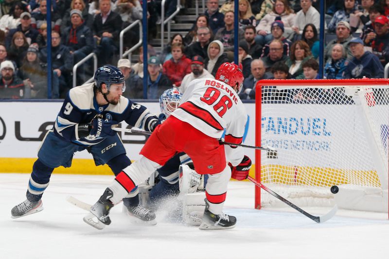 Dec 31, 2024; Columbus, Ohio, USA; Carolina Hurricanes center Jack Roslovic (96) scores a goal against the Columbus Blue Jackets during the second period at Nationwide Arena. Mandatory Credit: Russell LaBounty-Imagn Images