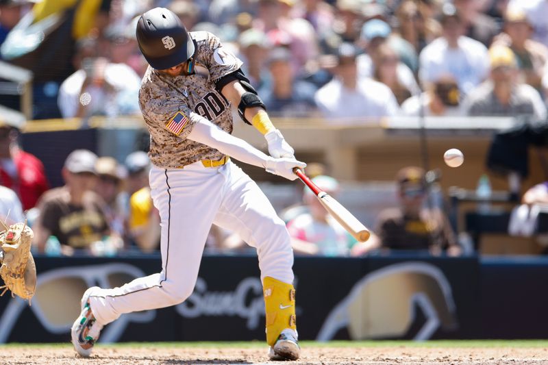 Aug 4, 2024; San Diego, California, USA; San Diego Padres catcher Kyle Higashioka (20) hits a one run home run during the fifth inning against the Colorado Rockies at Petco Park. Mandatory Credit: David Frerker-USA TODAY Sports