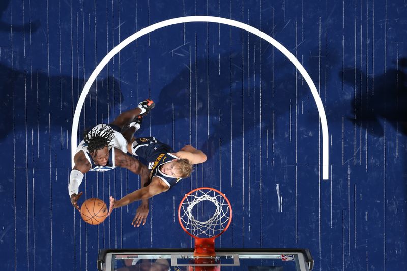 MINNEAPOLIS, MN -  OCTOBER 17: Leonard Miller #33 of the Minnesota Timberwolves drives to the basket during the game against the Denver Nuggets during the 2024 NBA Preseason on October 17, 2024 at Target Center in Minneapolis, Minnesota. NOTE TO USER: User expressly acknowledges and agrees that, by downloading and or using this Photograph, user is consenting to the terms and conditions of the Getty Images License Agreement. Mandatory Copyright Notice: Copyright 2024 NBAE (Photo by David Sherman/NBAE via Getty Images)