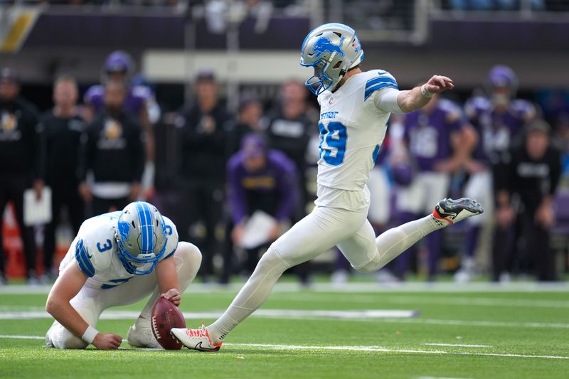 Detroit Lions place-kicker Jake Bates (39) kicks a 44-yard field goal out of the hold of Jack Fox (3) against the Minnesota Vikings during the second half of an NFL football game Sunday, Oct. 20, 2024, in Minneapolis. (AP Photo/Abbie Parr)