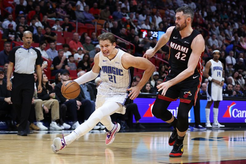 MIAMI, FLORIDA - FEBRUARY 06: Moritz Wagner #21 of the Orlando Magic drives against Kevin Love #42 of the Miami Heat during the first quarter of the game at Kaseya Center on February 06, 2024 in Miami, Florida. NOTE TO USER: User expressly acknowledges and agrees that, by downloading and or using this photograph, User is consenting to the terms and conditions of the Getty Images License Agreement. (Photo by Megan Briggs/Getty Images)