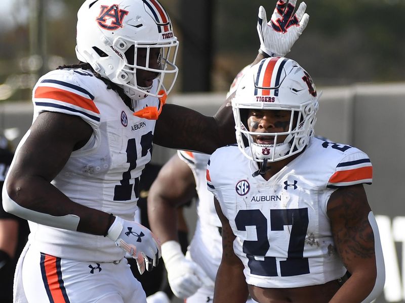 Nov 4, 2023; Nashville, Tennessee, USA; Auburn Tigers running back Jarquez Hunter (27) celebrates with tight end Rivaldo Fairweather (13) after a touchdown during the first half against the Vanderbilt Commodores at FirstBank Stadium. Mandatory Credit: Christopher Hanewinckel-USA TODAY Sports