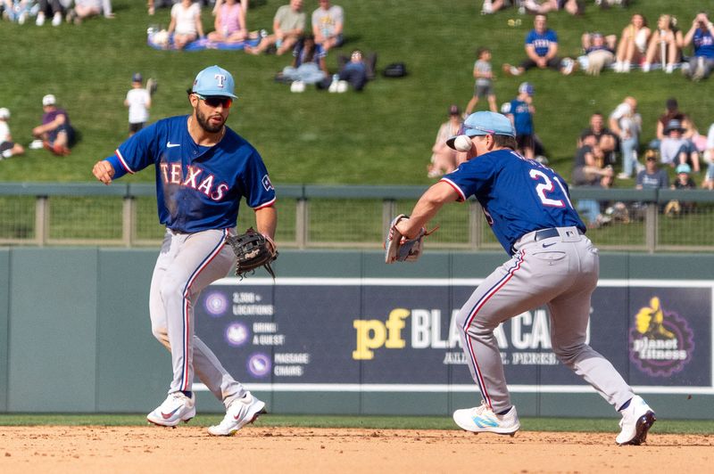 Mar 6, 2024; Salt River Pima-Maricopa, Arizona, USA; Texas Rangers infielders Cam Cauley (21) reacts after not catching a ground ball in the eighth during a spring training game against  the Colorado Rockies at Salt River Fields at Talking Stick. Mandatory Credit: Allan Henry-USA TODAY Sports