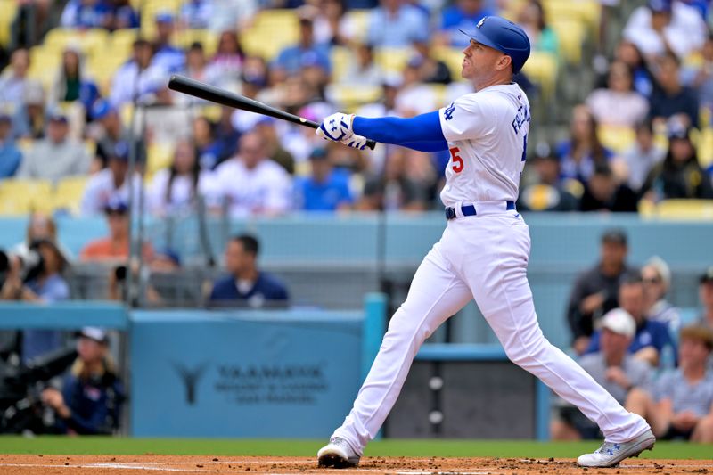 Jun 2, 2024; Los Angeles, California, USA;  Los Angeles Dodgers first base Freddie Freeman (5) hits a solo home run in the first inning against the Colorado Rockies at Dodger Stadium. Mandatory Credit: Jayne Kamin-Oncea-USA TODAY Sports