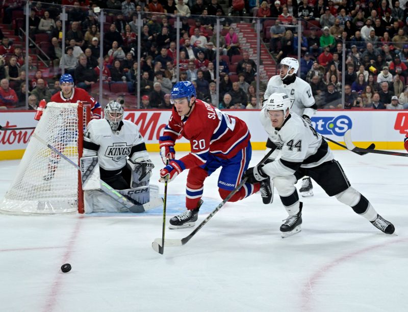 Oct 17, 2024; Montreal, Quebec, CAN;Montreal Canadiens forward Juraj Slafkovsky (20) and Los Angeles Kings defenseman Mikey Anderson (44) chase the puck during the second period at the Bell Centre. Mandatory Credit: Eric Bolte-Imagn Images