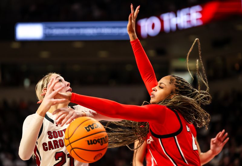 Feb 18, 2024; Columbia, South Carolina, USA; Georgia Lady Bulldogs forward Jordan Cole (20) knocks the ball from South Carolina Gamecocks forward Chloe Kitts (21) in the second half at Colonial Life Arena. Mandatory Credit: Jeff Blake-USA TODAY Sports