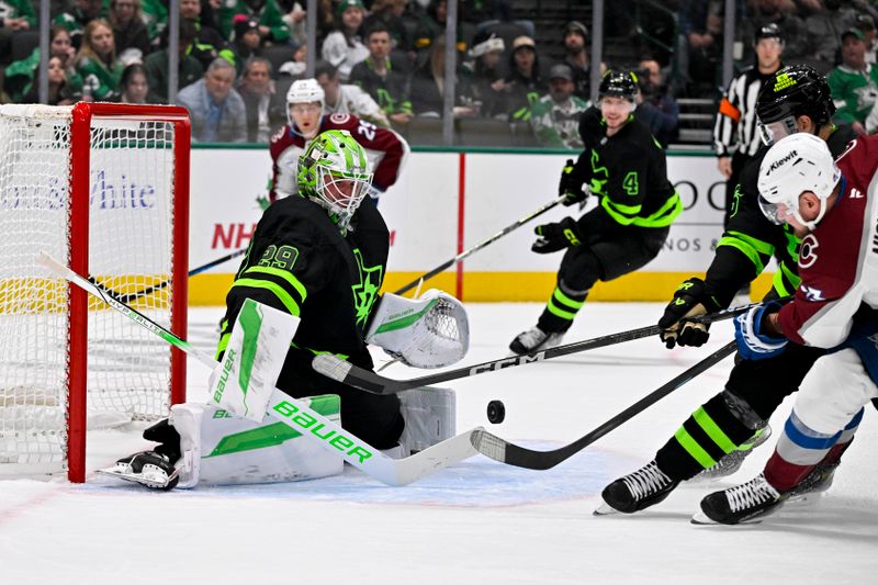 Nov 29, 2024; Dallas, Texas, USA; Dallas Stars goaltender Jake Oettinger (29) stops a shot by Colorado Avalanche right wing Valeri Nichushkin (13) during the third period at the American Airlines Center. Mandatory Credit: Jerome Miron-Imagn Images