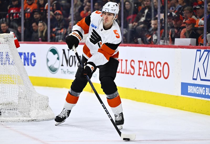 Apr 13, 2024; Philadelphia, Pennsylvania, USA; Philadelphia Flyers defenseman Egor Zamula (5) passes the puck against the New Jersey Devils in the second period at Wells Fargo Center. Mandatory Credit: Kyle Ross-USA TODAY Sports