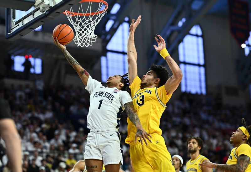 Jan 7, 2024; Philadelphia, Pennsylvania, USA; Penn State Nittany Lions guard Ace Baldwin Jr (1) shoots against Michigan Wolverines forward Olivier Nkamhoua (13) in the first half at The Palestra. Mandatory Credit: Kyle Ross-USA TODAY Sports