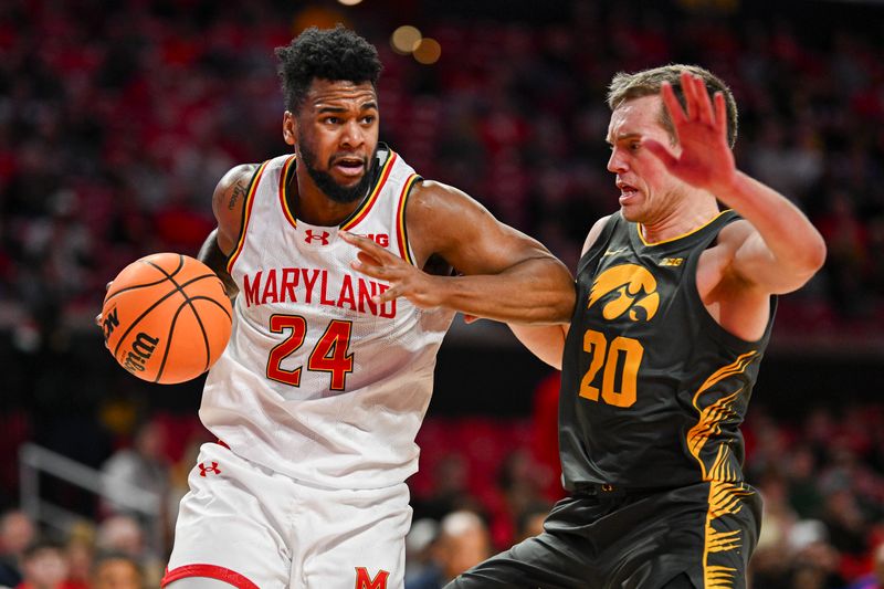 Feb 14, 2024; College Park, Maryland, USA;  Maryland Terrapins forward Donta Scott (24) makes a move to the basket on Iowa Hawkeyes forward Payton Sandfort (20) during the second half at Xfinity Center. Mandatory Credit: Tommy Gilligan-USA TODAY Sports