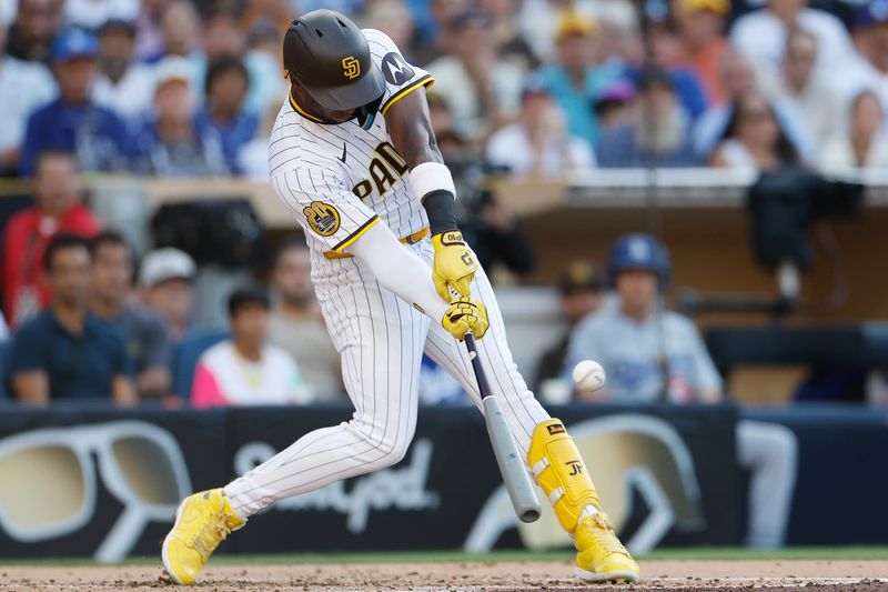 Jul 31, 2024; San Diego, California, USA; San Diego Padres left fielder Jurickson Profar (10) hits an RBI single during the second inning against the Los Angeles Dodgers at Petco Park. Mandatory Credit: David Frerker-USA TODAY Sports